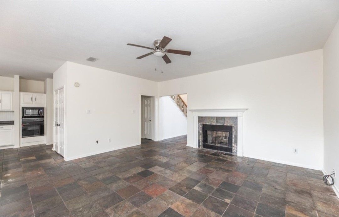 2515 Falcon Ridge Street Pearland, TX 77584 - Photo 12 of 31 a view of a livingroom with a fireplace and a window