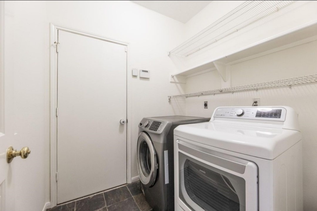 2515 Falcon Ridge Street Pearland, TX 77584 - Photo 18 of 31 a utility room with dryer and washer