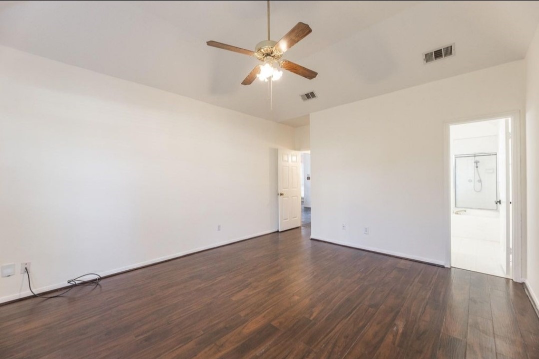 2515 Falcon Ridge Street Pearland, TX 77584 - Photo 20 of 31 an empty room with wooden floor ceiling fan and window