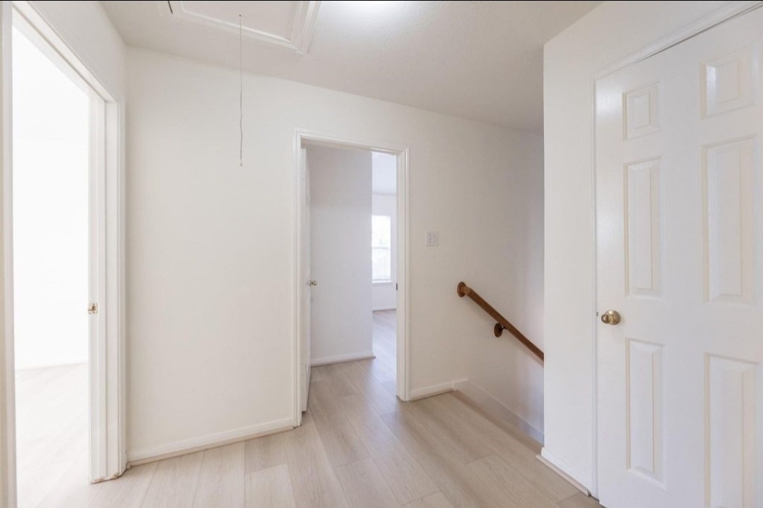 2515 Falcon Ridge Street Pearland, TX 77584 - Photo 25 of 31 a view of a hallway with wooden floor