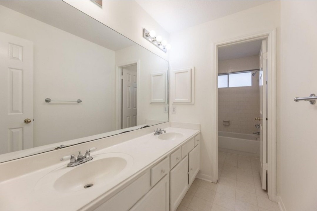 2515 Falcon Ridge Street Pearland, TX 77584 - Photo 29 of 31 a bathroom with a double vanity sink a and mirror