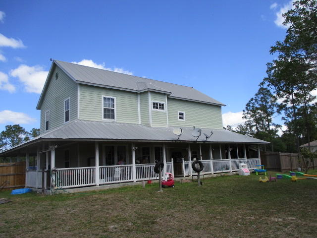 16728 78th Road North Loxahatchee, FL 33470 - Photo 6 of 23 a front view of a house with a garden