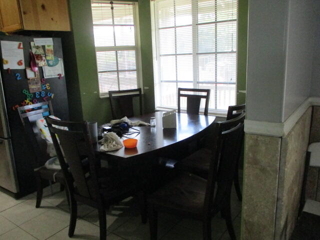 16728 78th Road North Loxahatchee, FL 33470 - Photo 8 of 23 a kitchen with a table chairs and a refrigerator