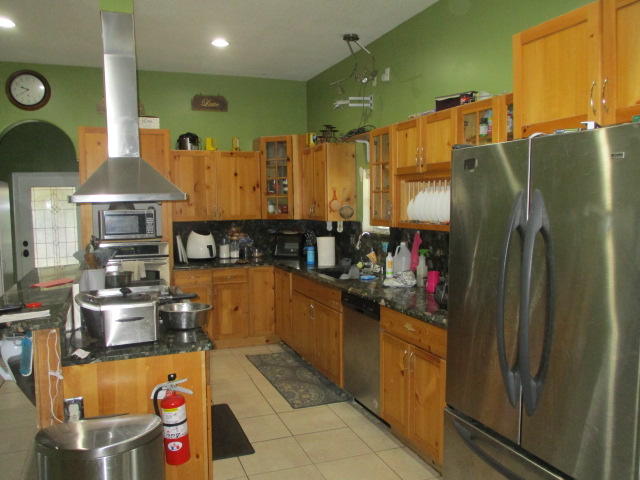 16728 78th Road North Loxahatchee, FL 33470 - Photo 9 of 23 a kitchen with stainless steel appliances a refrigerator and a stove