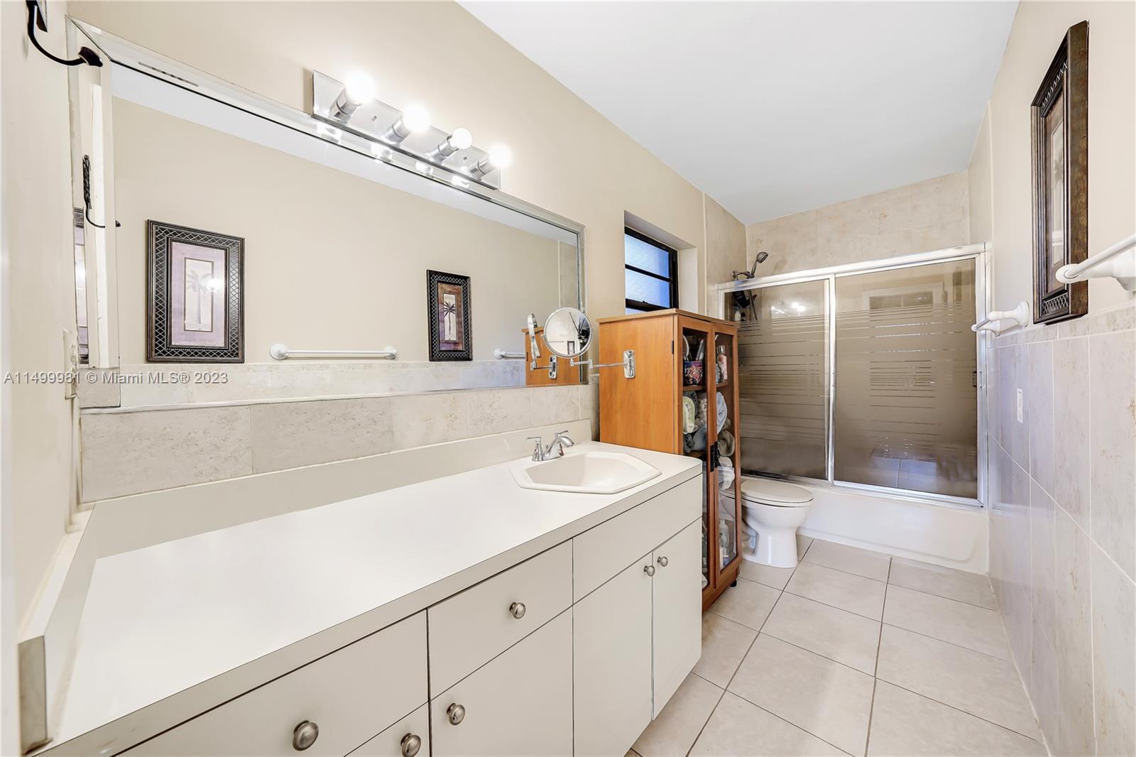 2755 Southwest 33rd Court Miami, FL 33133 - Photo 15 of 22 a bathroom with a sink a large mirror and a shower