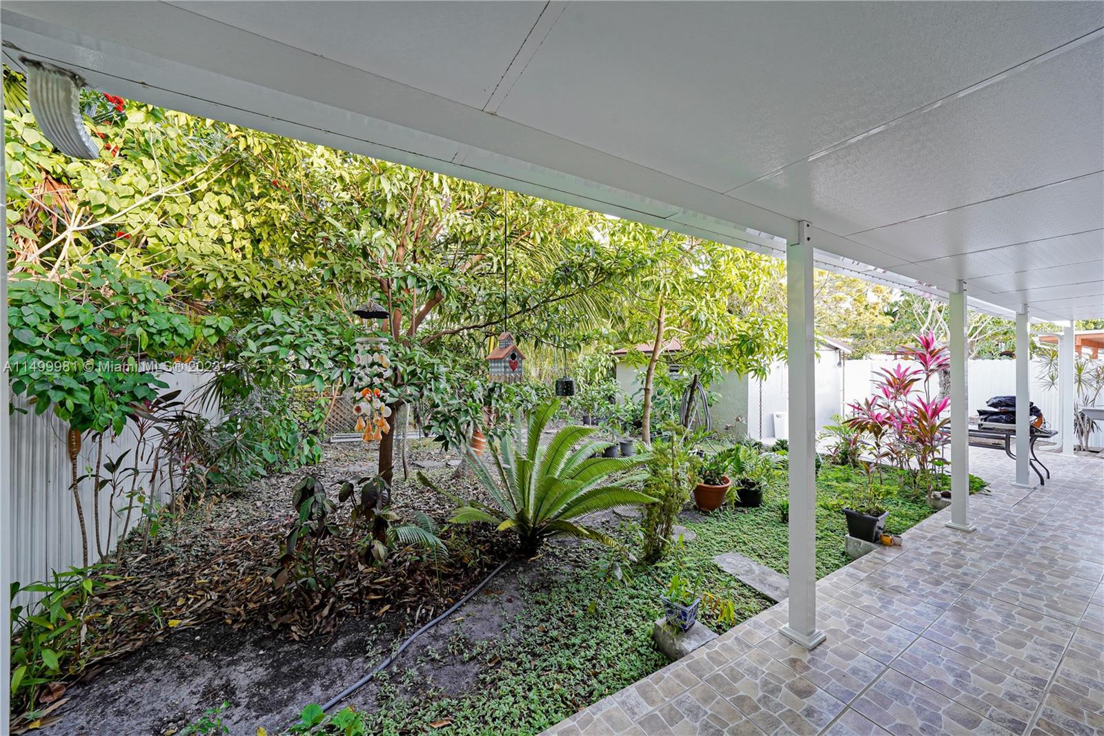 2755 Southwest 33rd Court Miami, FL 33133 - Photo 17 of 22 a view of a garage with plants and a bench in it