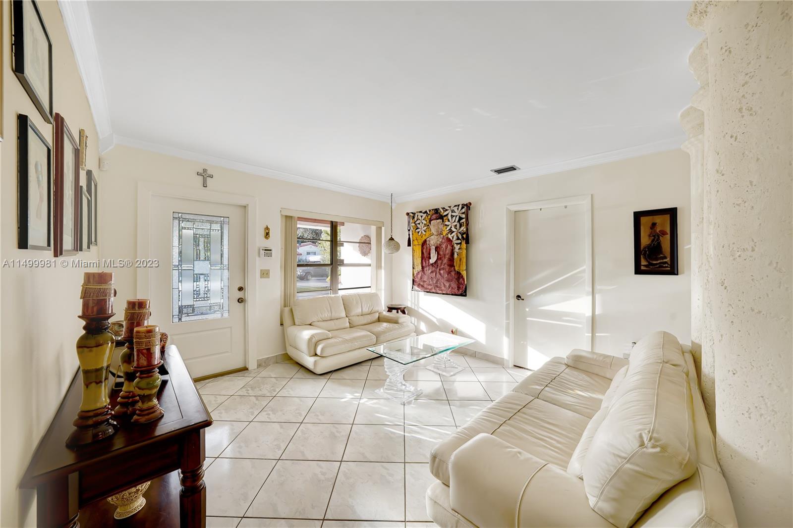 2755 Southwest 33rd Court Miami, FL 33133 - Photo 2 of 22 a living room with furniture a rug and white walls