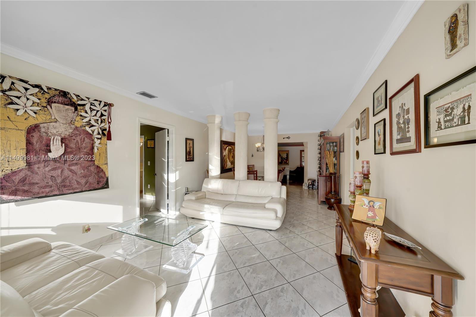 2755 Southwest 33rd Court Miami, FL 33133 - Photo 3 of 22 a view of a hallway with wooden floor and furniture