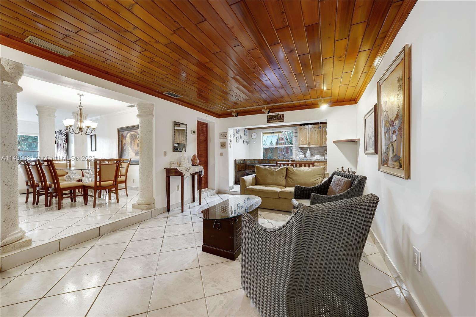 2755 Southwest 33rd Court Miami, FL 33133 - Photo 4 of 22 a living room with furniture a dining table and chairs with a large window