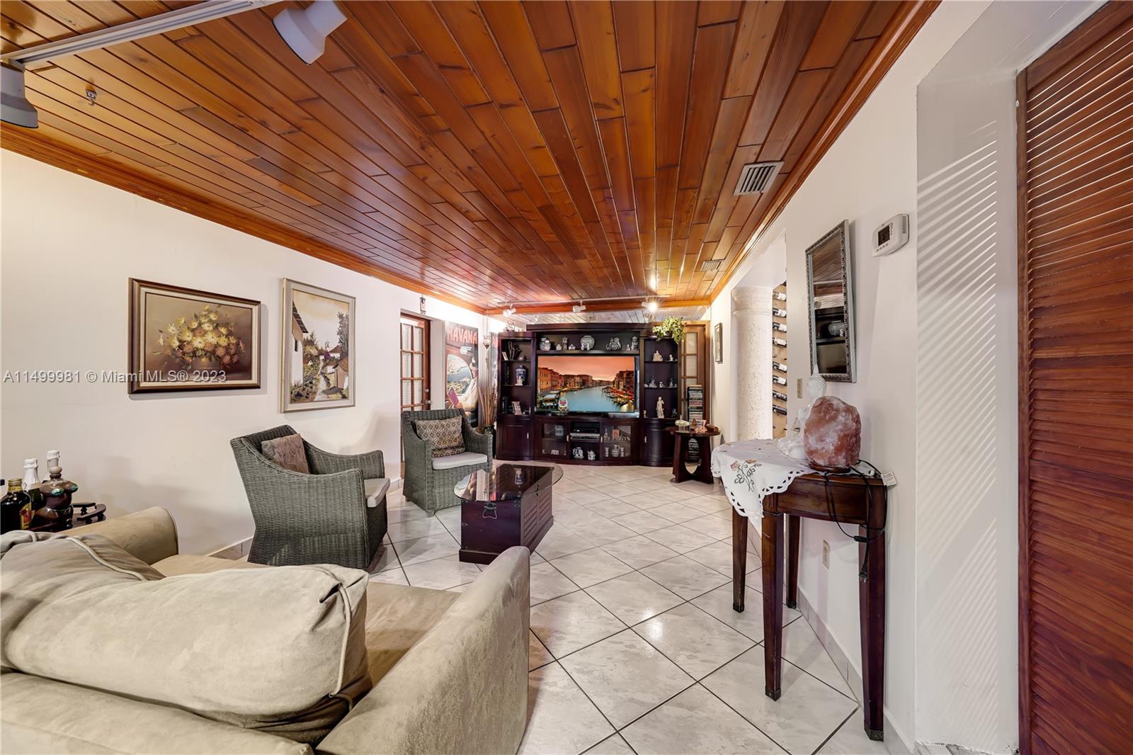 2755 Southwest 33rd Court Miami, FL 33133 - Photo 5 of 22 a living room with furniture and a chandelier