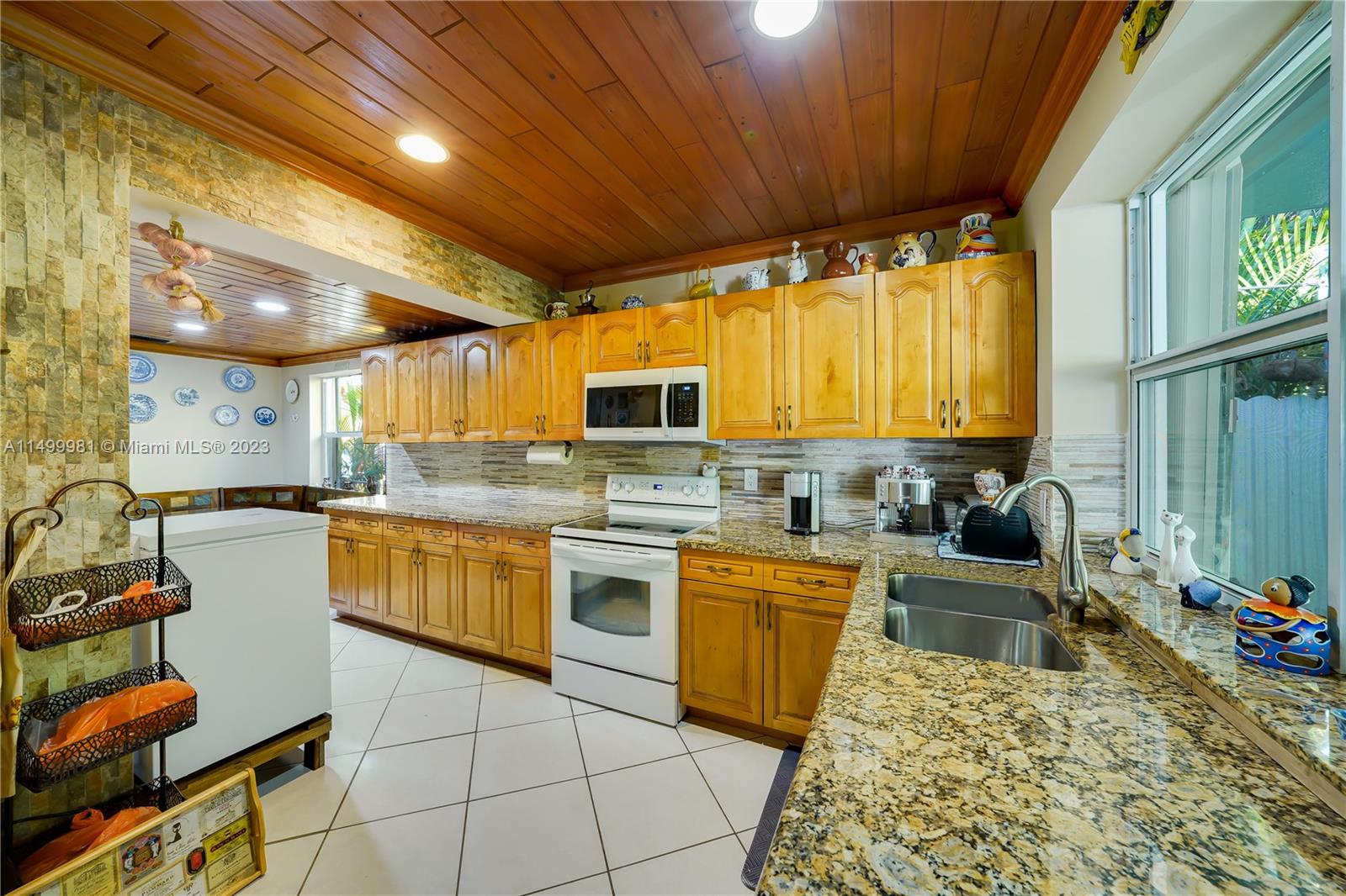 2755 Southwest 33rd Court Miami, FL 33133 - Photo 9 of 22 a kitchen with stainless steel appliances granite countertop sink stove and cabinets