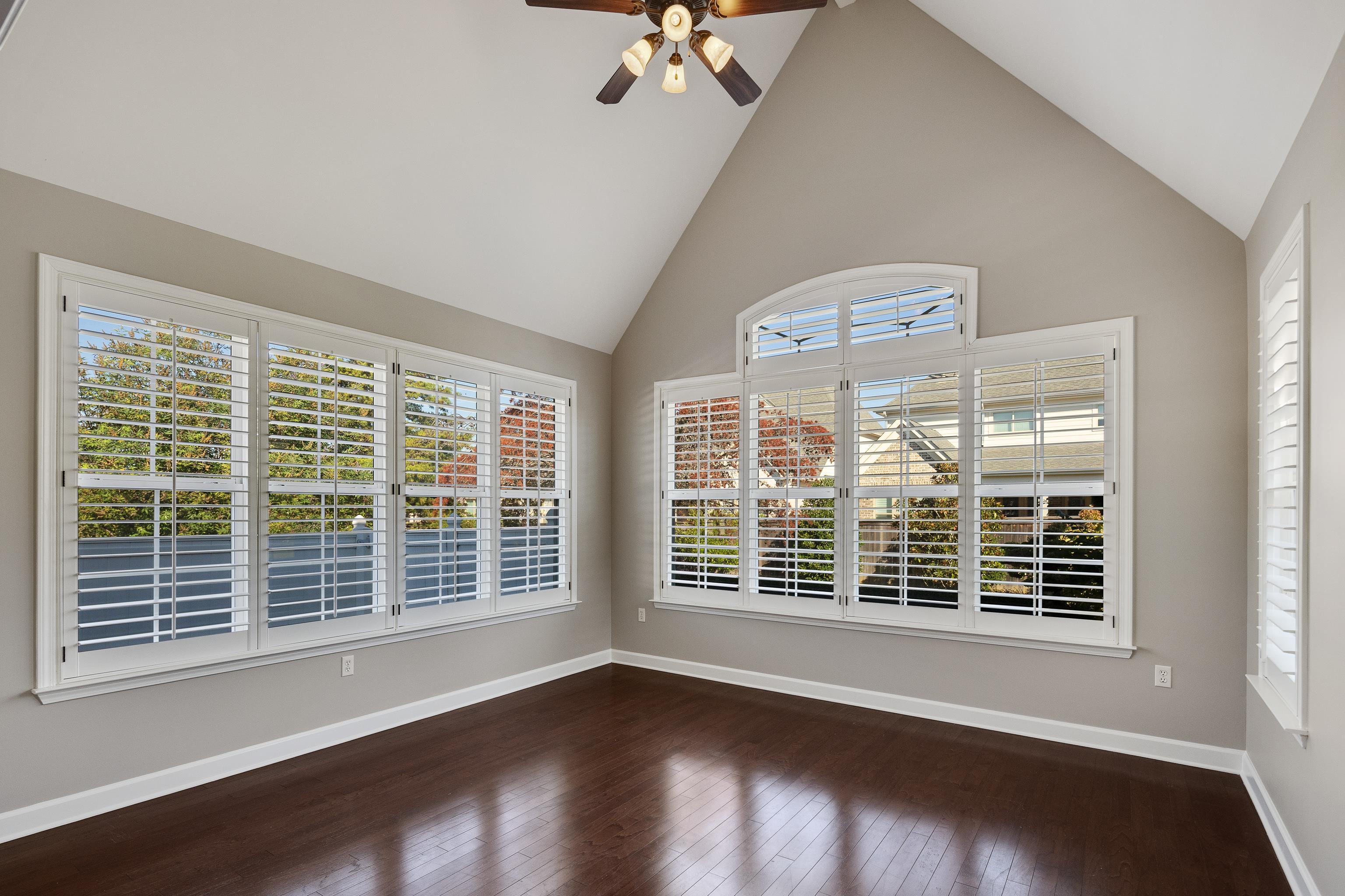 1422 Calumet Farms Drive, Unit 7 Collierville, TN 38017 - Photo 11 of 29 a view of an empty room with wooden floor and a window