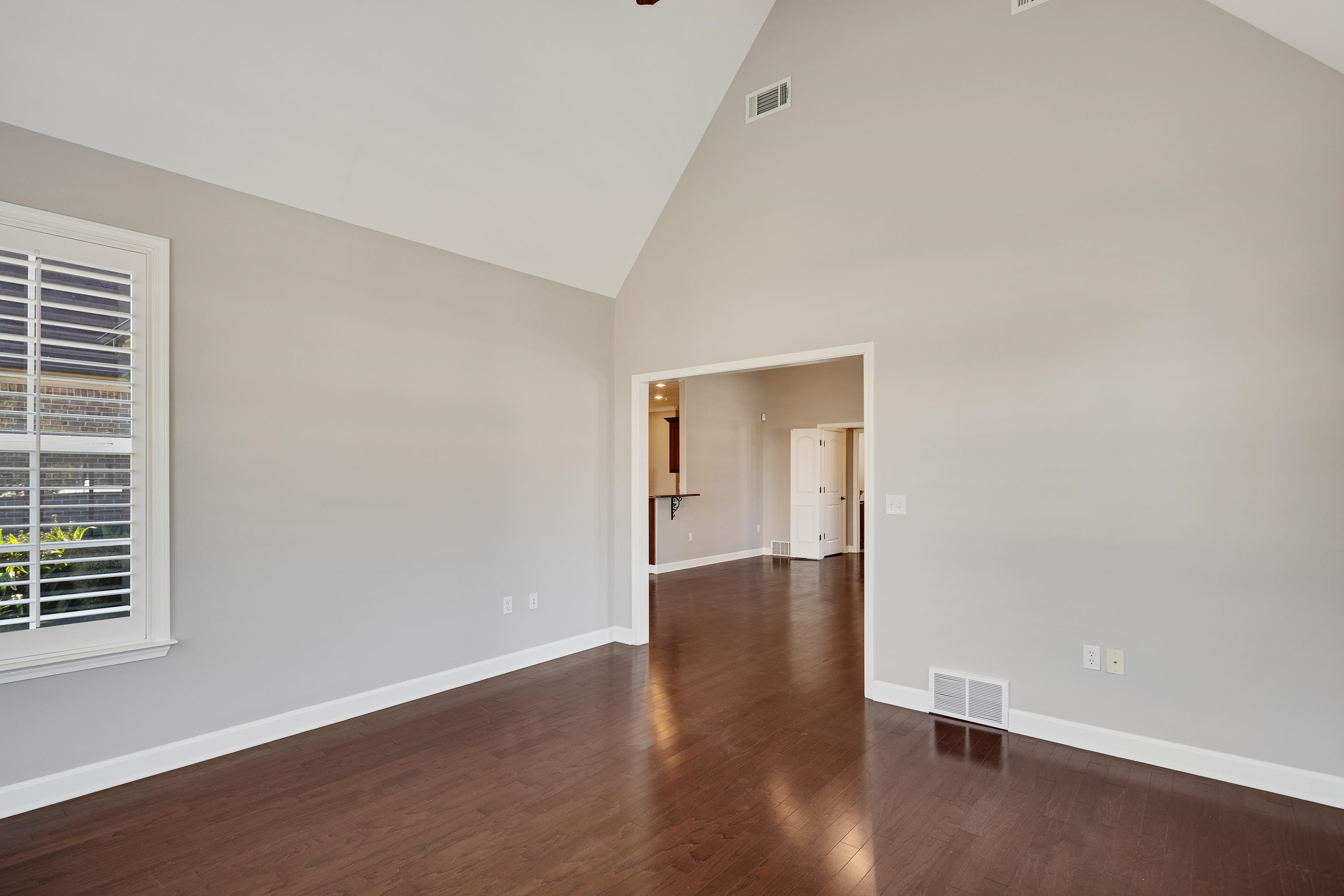 1422 Calumet Farms Drive, Unit 7 Collierville, TN 38017 - Photo 12 of 29 a view of an empty room with wooden floor and a window
