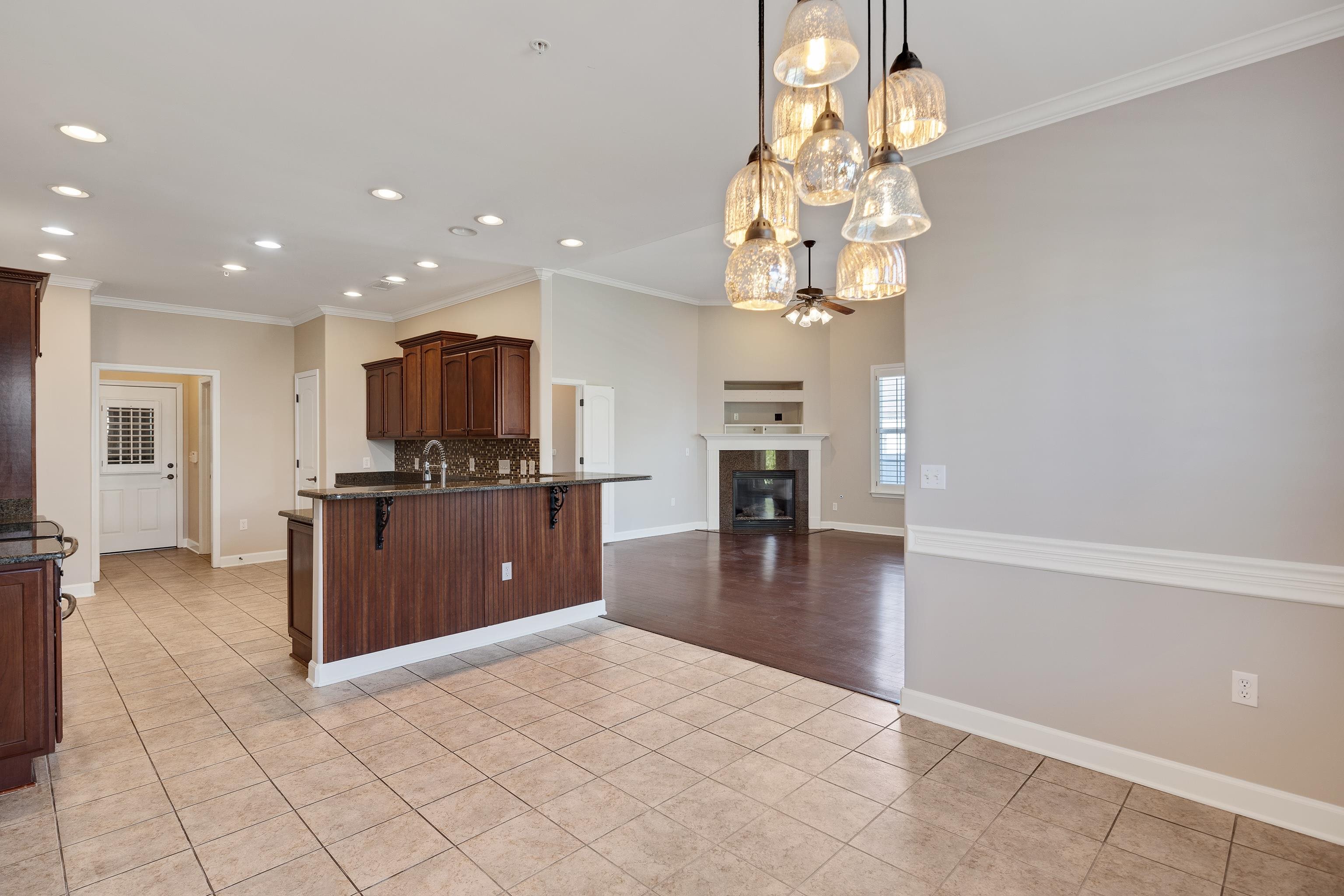 1422 Calumet Farms Drive, Unit 7 Collierville, TN 38017 - Photo 14 of 29 a kitchen with stainless steel appliances granite countertop a refrigerator and a sink