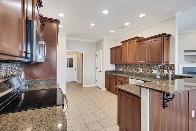 a kitchen with a sink stove and cabinets