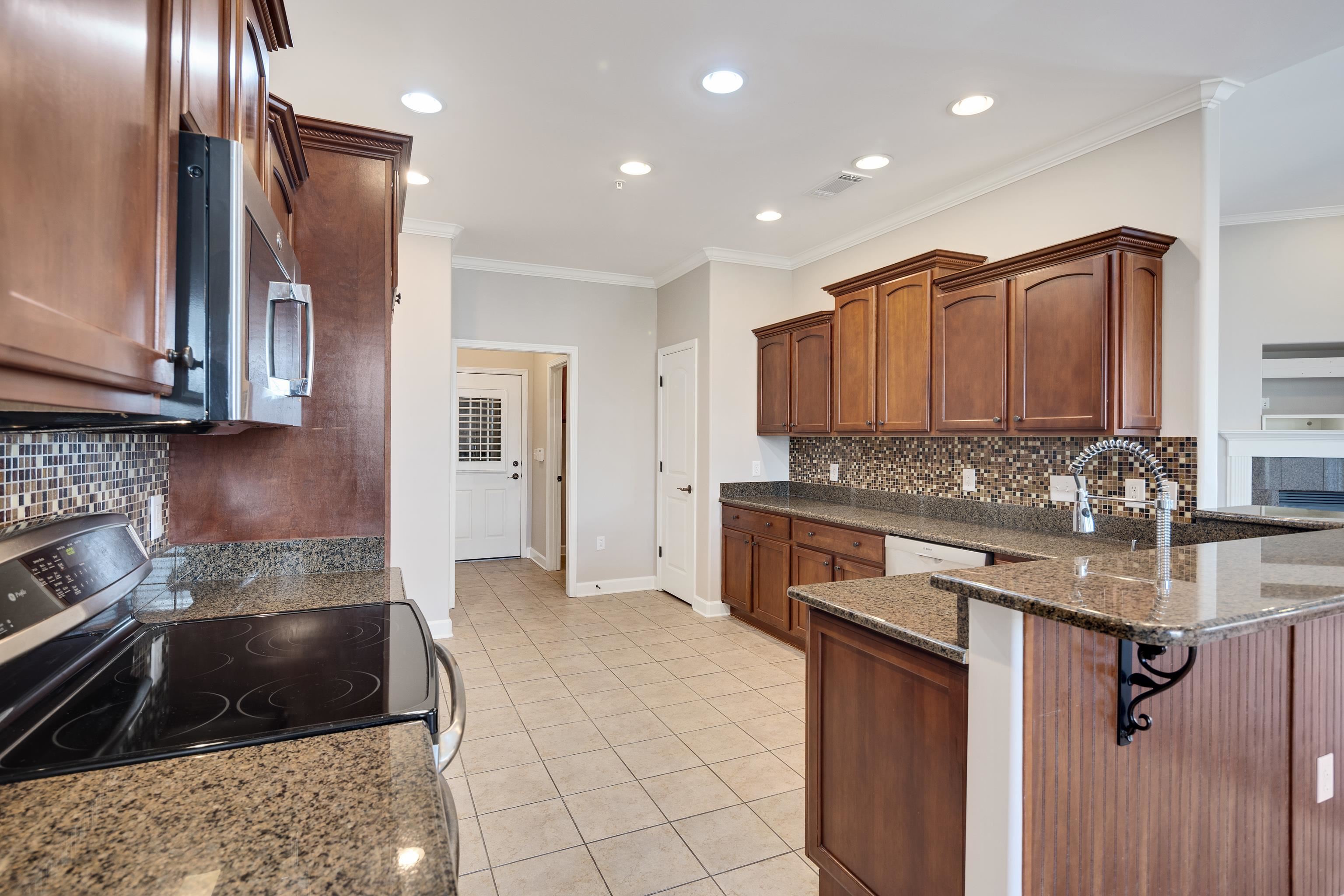 1422 Calumet Farms Drive, Unit 7 Collierville, TN 38017 - Photo 15 of 29 a kitchen with a sink stove and cabinets