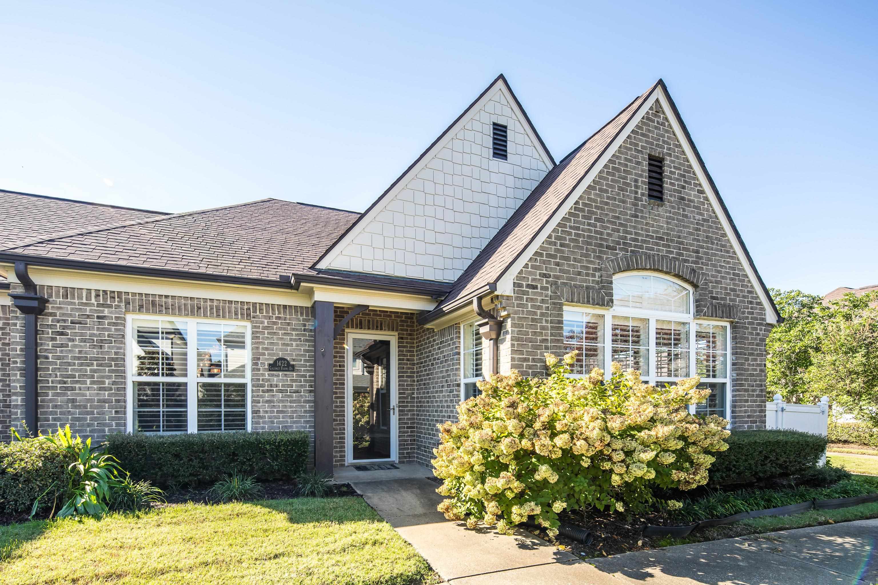 1422 Calumet Farms Drive, Unit 7 Collierville, TN 38017 - Photo 2 of 29 a front view of a house with garden