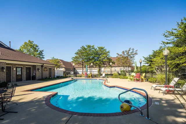 a swimming pool with outdoor seating and yard