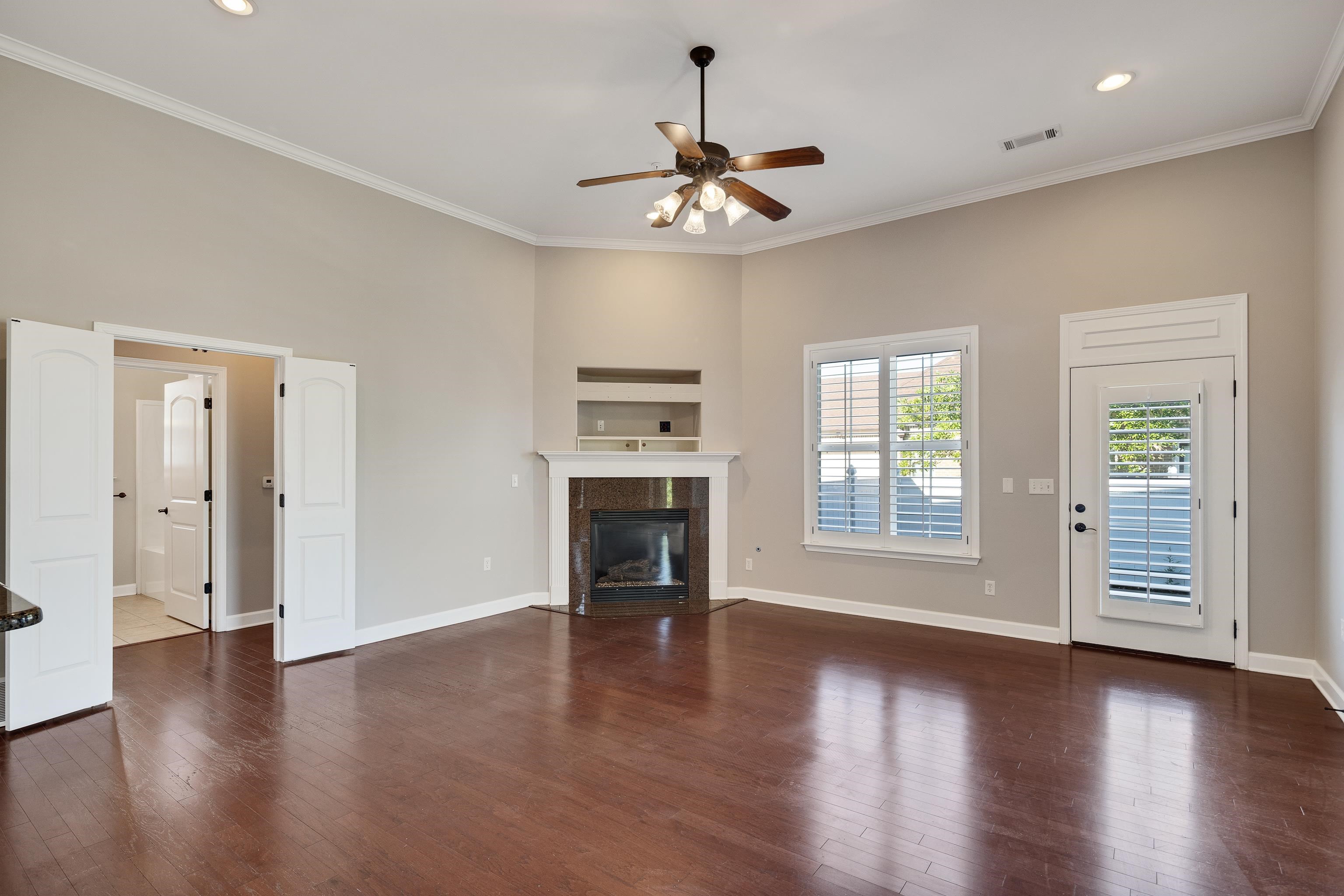 1422 Calumet Farms Drive, Unit 7 Collierville, TN 38017 - Photo 7 of 29 a view of an empty room with a window and wooden floor