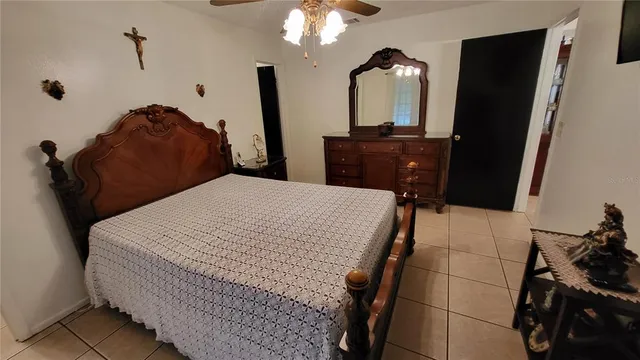 a bedroom with a bed and a mirror