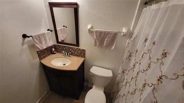 a bathroom with a sink toilet and mirror