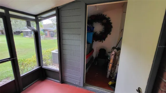 a view of a porch with furniture and a yard