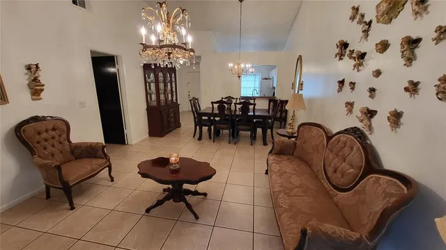 a living room with furniture a chandelier a rug and a chandelier
