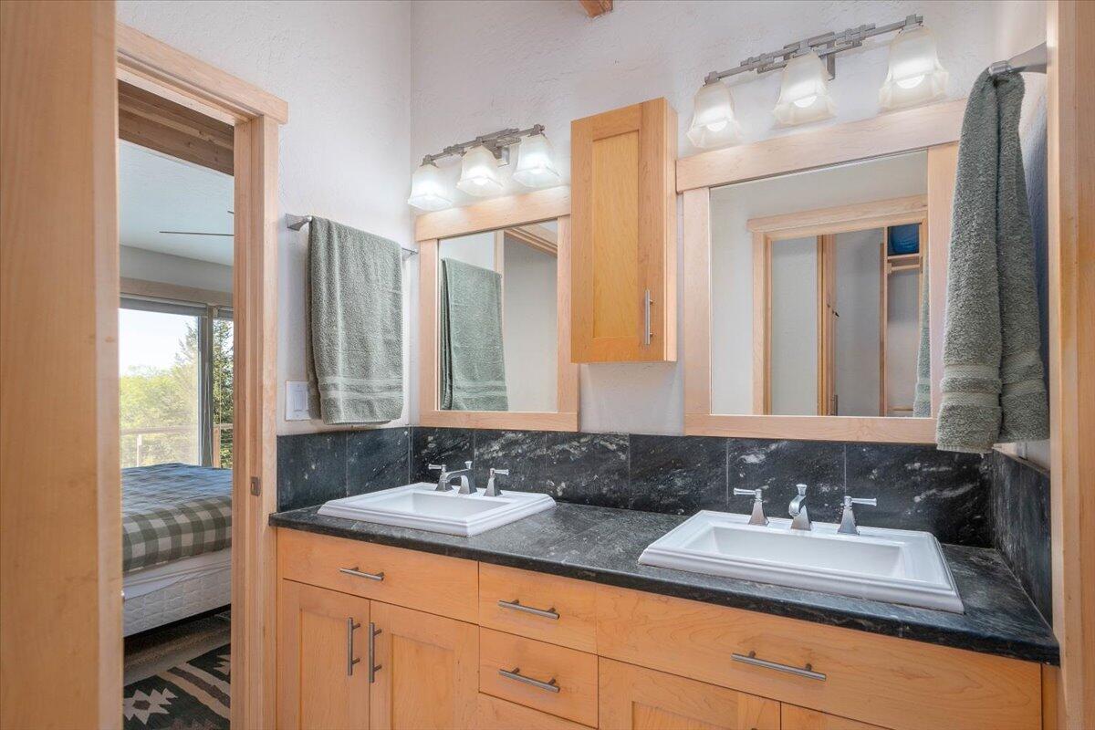 19649 Cove Road Montgomery Creek, CA 96065 - Photo 29 of 65 a bathroom with double sink and a mirror