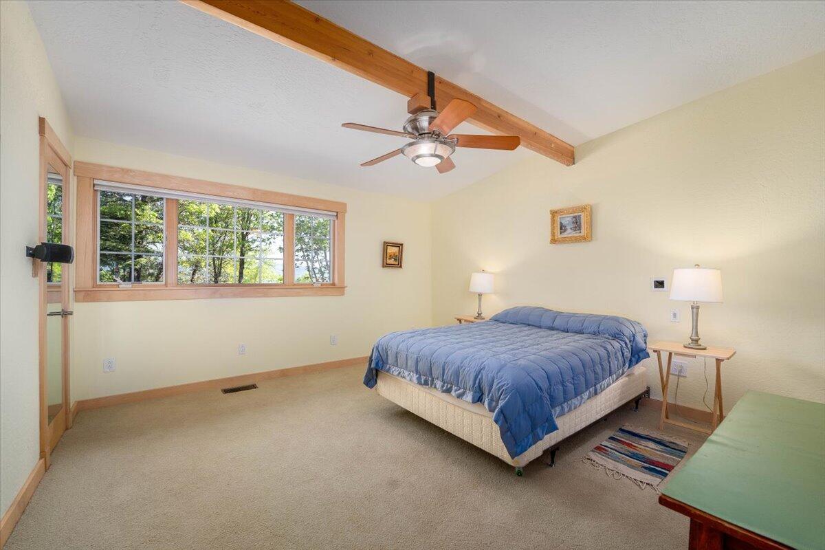 19649 Cove Road Montgomery Creek, CA 96065 - Photo 33 of 65 a spacious bedroom with a bed and window