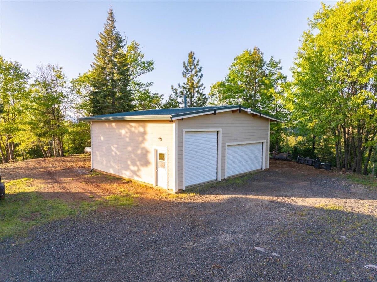 19649 Cove Road Montgomery Creek, CA 96065 - Photo 51 of 65 a view of backyard with large tree and wooden fence