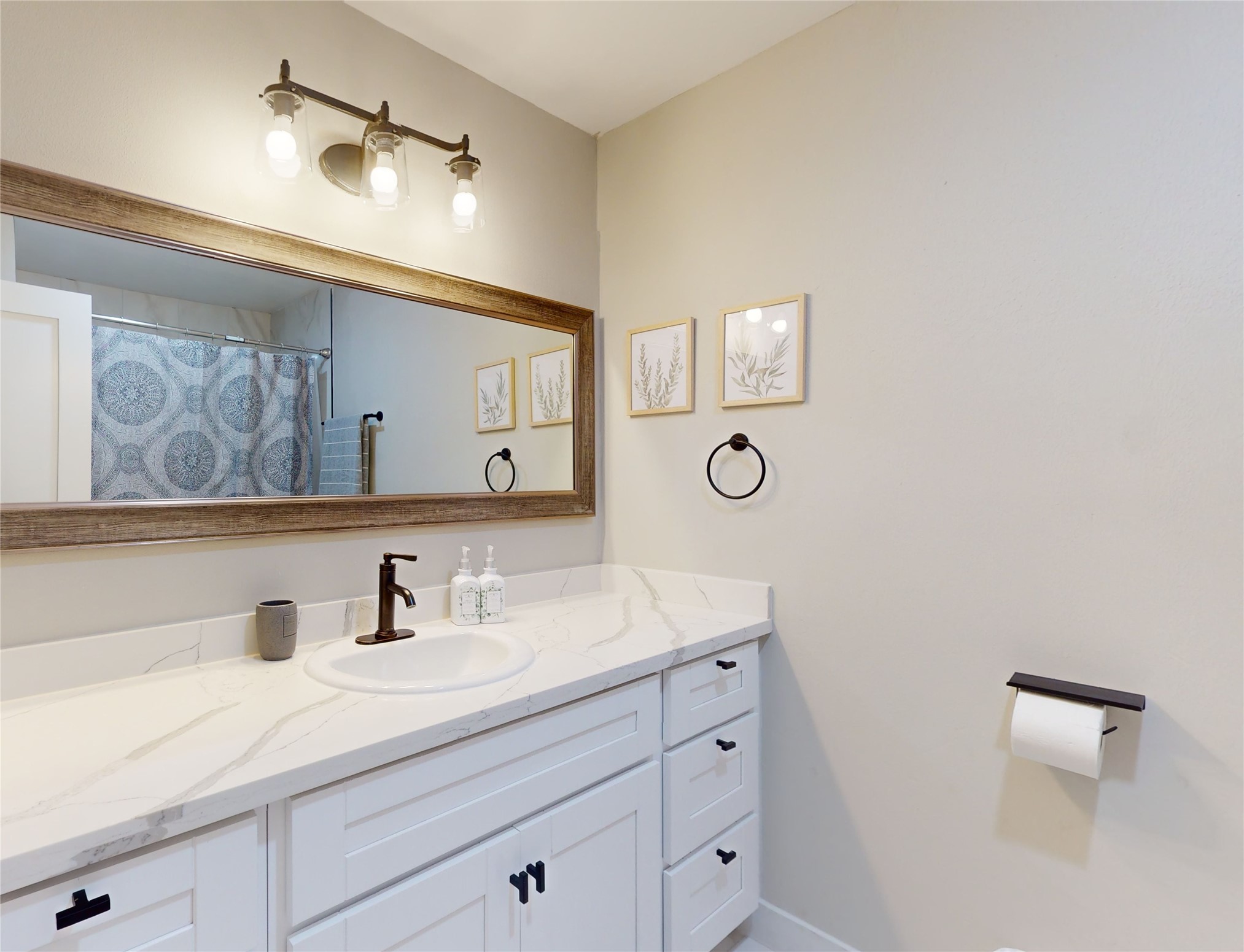 5455 Birdwood Road Houston, TX 77096 - Photo 18 of 26 a bathroom with a sink and a mirror