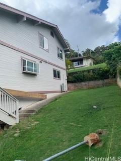 45-906 Anoi Road, Unit A Kaneohe, HI 96744 - Photo 3 of 19 a front view of a house with a garden and yard
