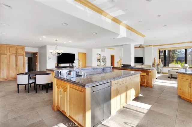 a large kitchen with a large counter top appliances and cabinets