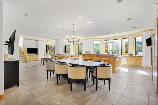 a large kitchen with a table and chairs
