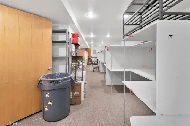 a hallway with a white cabinets and wooden floor