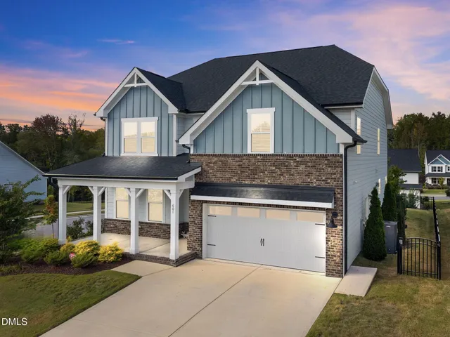 a front view of a house with a garden