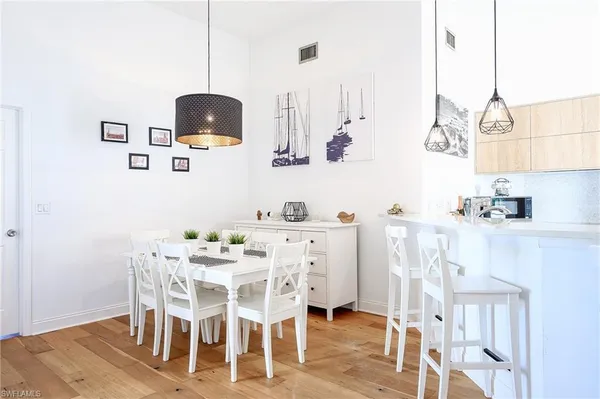 a dining room with furniture and wooden floor