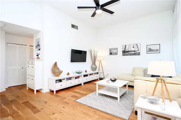 a living room with furniture and flat screen tv