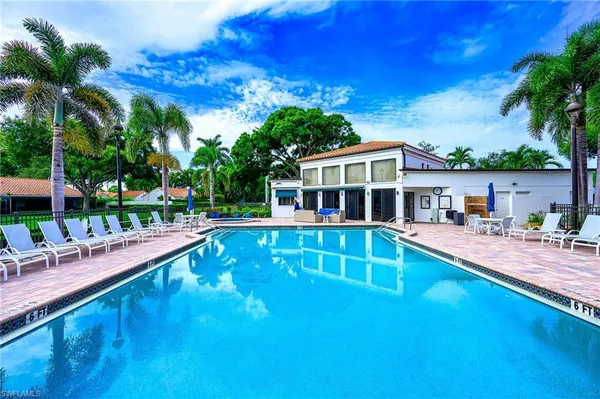 a view of a house with swimming pool and sitting area