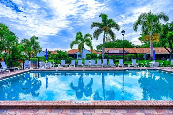 a swimming pool with outdoor seating and yard