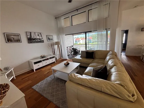 a living room with furniture a rug and a large window