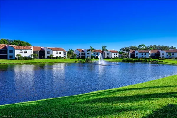 a view of a lake with a house in the background