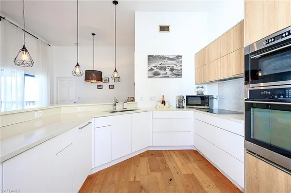 a kitchen with a sink stove and microwave