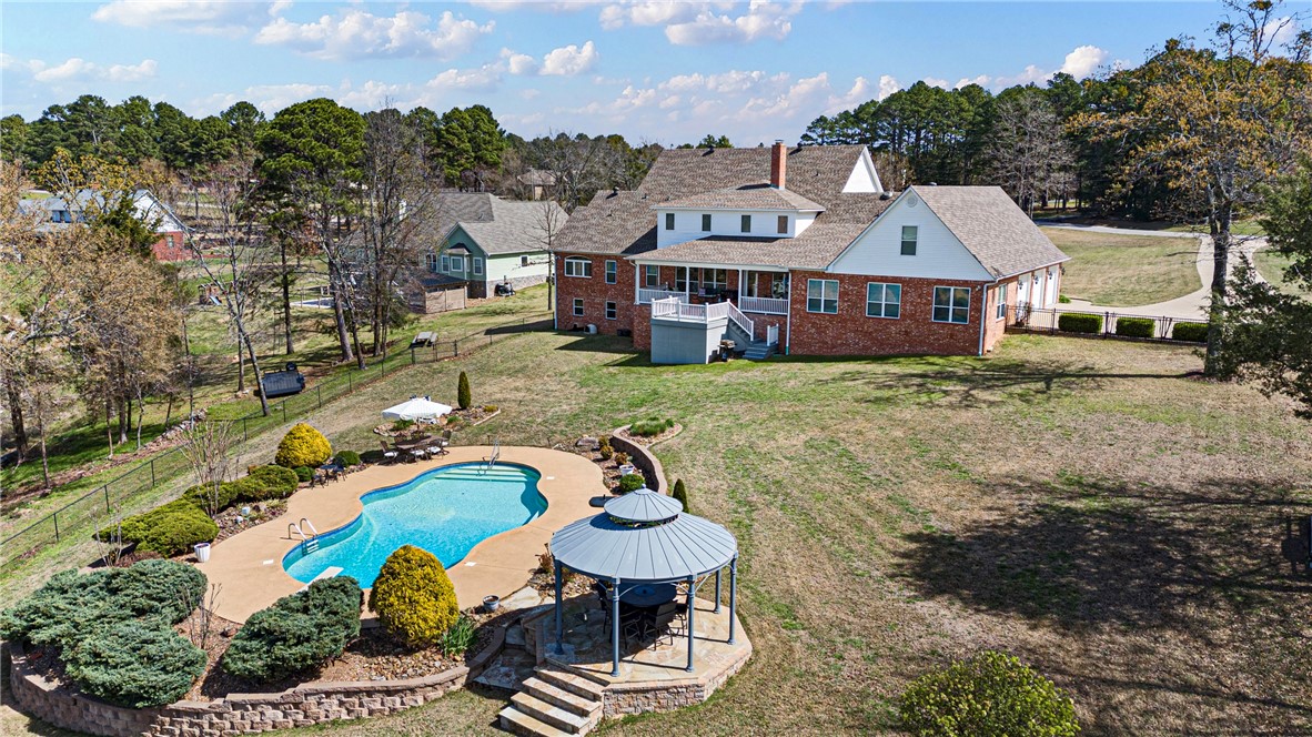788 Cliff Road Russellville, AR 72802 - Photo 50 of 60 Back of property with a patio, an outdoor pool, brick siding, and view of scattered trees