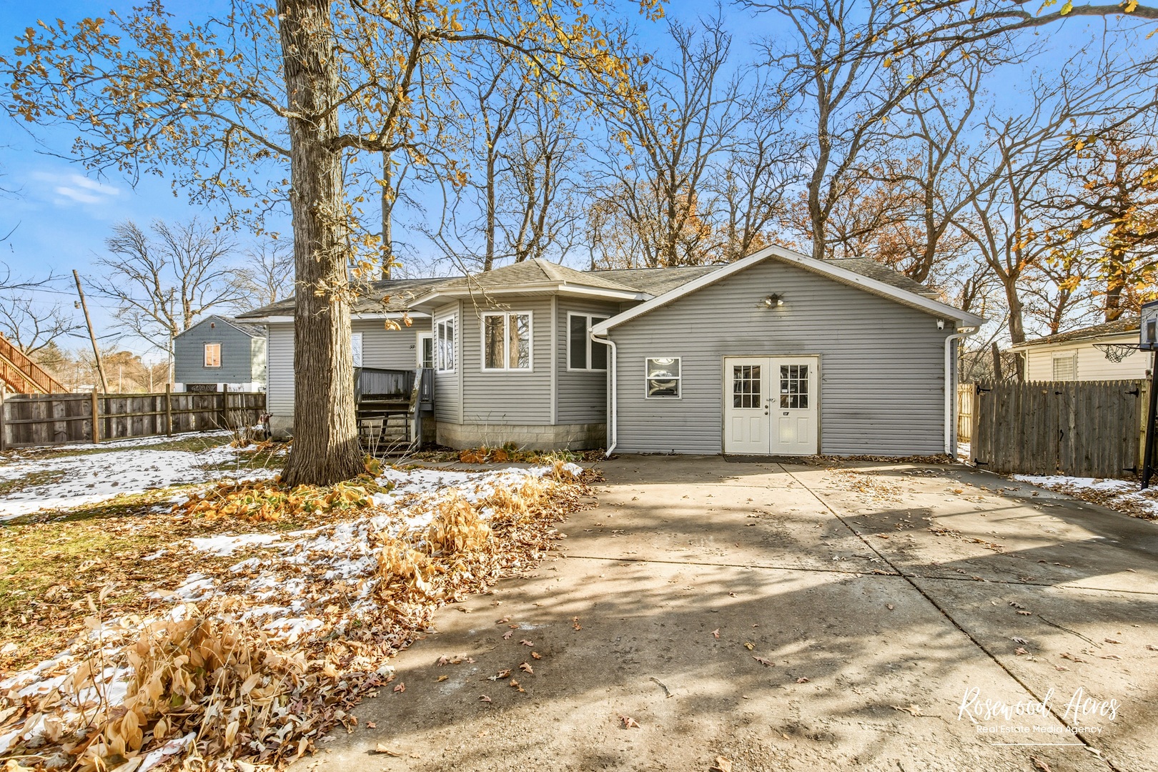 a front view of a house with a yard and covered with snow