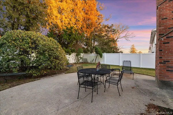 a backyard of a house with table and chairs