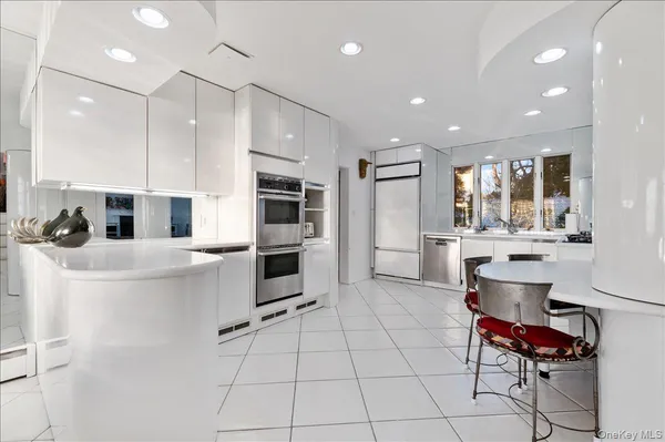 a kitchen with stainless steel appliances kitchen island granite countertop a sink and cabinets