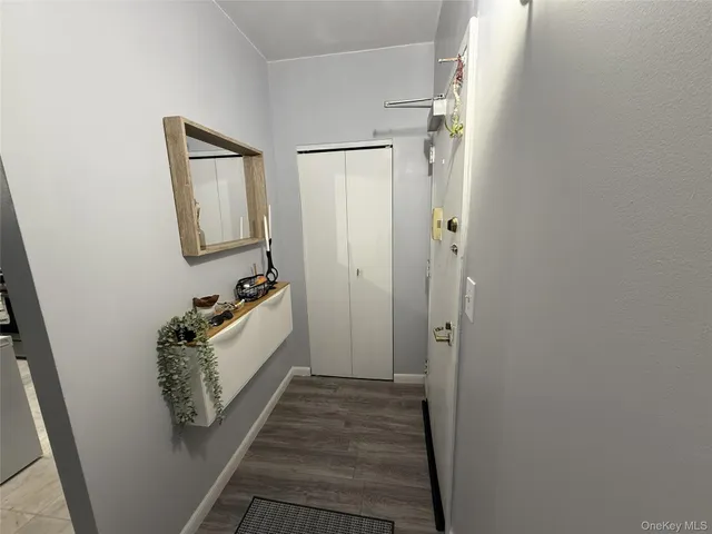 a room with a mirror and a wooden floor