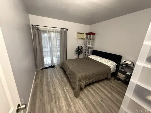 a bedroom with a bed and window