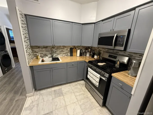 a kitchen with a sink stove and microwave